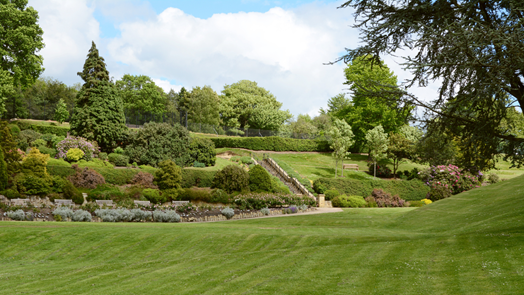 An ornamental garden with green trees and bushes  at the public park in Calverley Grounds, Tunbridge Wells.