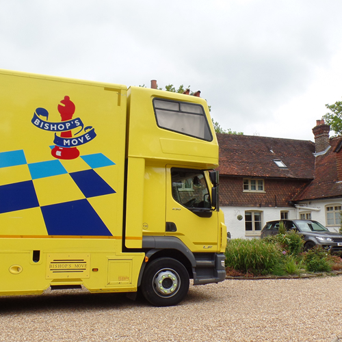 Yellow Bishop's move lorry outside a home
