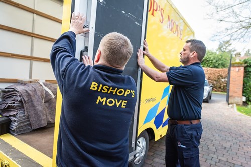 Two Bishop Moves employee opening a removal truck door