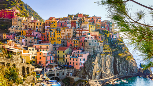Colourful hilltop houses by the sea in Italy