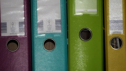 A row of document folders in various colours