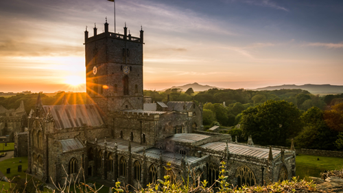 The sun setting behind St David’s Cathedral, Wales
