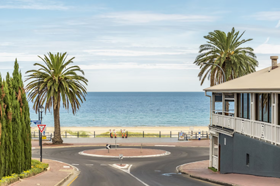 View down a street towards a sandy beach of Adelaide
