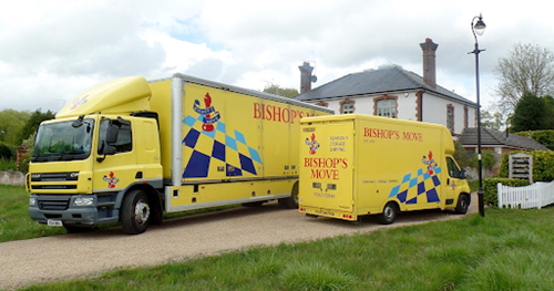 Two yellow Bishop’s Move vehicles outside a residential property