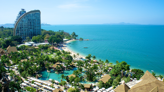 Tall hotel building on the sandy shores of Pattaya, Thailand.