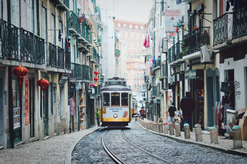 Tram driving through the streets of Lisbon, a popular destination for British expats