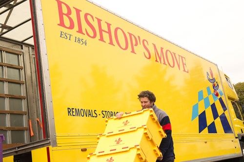 Bishop’s Move employee wheeling boxes into a truck