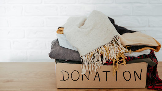 Donation box containing clothes and a scarf
