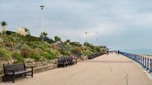 Eastbourne’s Victorian promenade with brown benches and flower beds