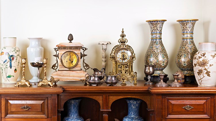 A collection of antique vases, clocks, and candlesticks.