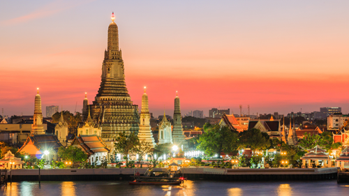 Sunset behind Wat Arun Temple in Bangkok, Thailand