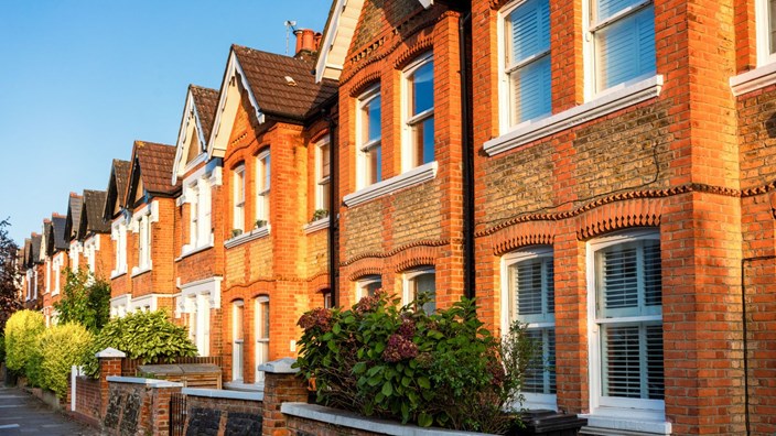 Victorian brick terraced houses in Ealing, West London on a summer day.
