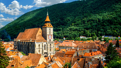 Brasov Romania cityscape with cathedral and mountain in the background
