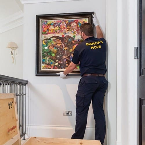 Bishops Move employee carefully moving artwork